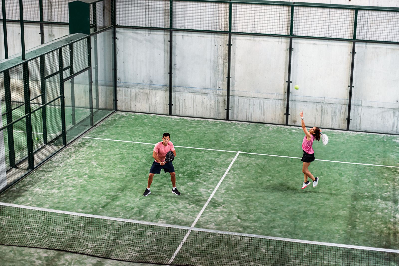 Doubles padel match in play on an indoor padel court